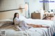 A woman laying on a bed in a hotel room.