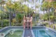 A group of women standing next to a swimming pool.