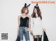 two girls in bunny ears standing next to each other